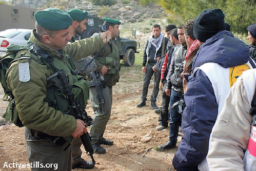 Soldiers prevent activists from reaching the main gate of the E1 area where the Palestinian outpost , From ImagesAttr