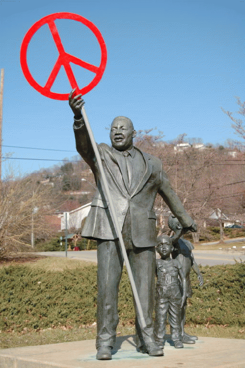 MLK statue in Asheville, NC  (Peace symbol supplied by PeaceTown)