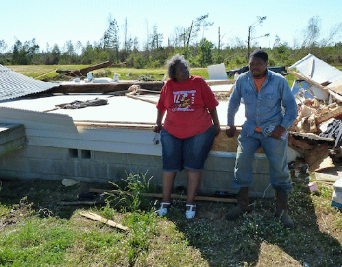 Ethel Giles and Dedrick Benison lean against what's left of Benison's house.Stil, From ImagesAttr