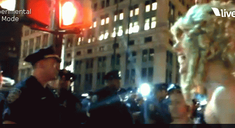 Lady Liberty Wrapped in American Flag Talks to NYPD, From ImagesAttr