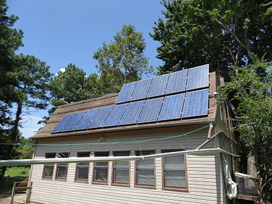 Jacobs' office/garage building with 14 solar panels, adjacent to the house.