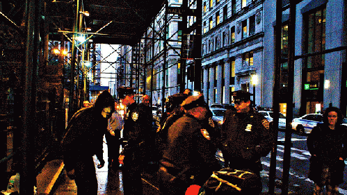 Police throw out OWS information fliers into the street., From ImagesAttr