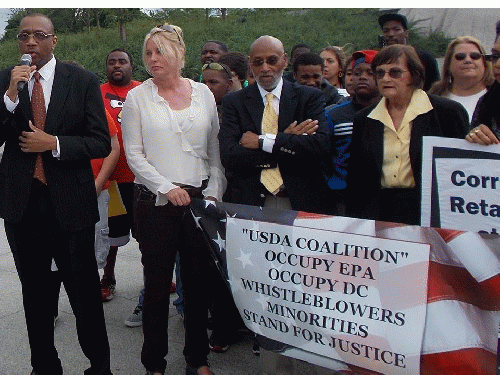 Michael McCray (on mic), Lawrence Lucas (arms folded) and others at rally.