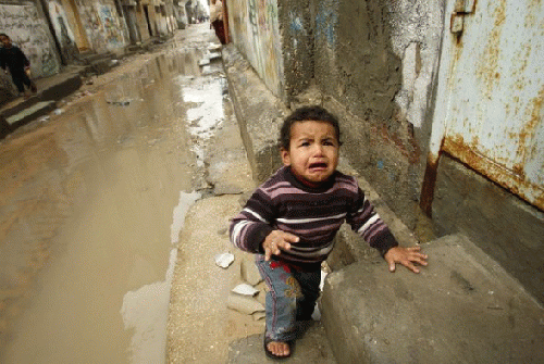 A Palestinian boy cries as he arrives at his home after walking through puddles in Shati refugee camp in Gaza City February 19, 2012, From ImagesAttr