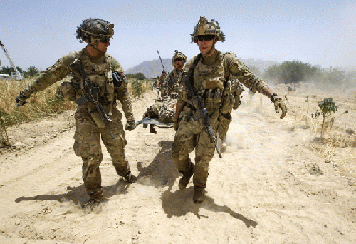 U.S. Army soldiers carry Sgt. Matt Krumwiede, who was wounded by an improvised explosive device (IED), towards a Blackhawk Medevac helicopter in southern Afghanistan June 12, 2012., From ImagesAttr