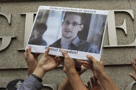 Protesters supporting Edward Snowden hold a photo of him during a demonstration outside the U.S. Consulate in Hong Kong.