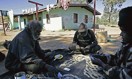 Aboriginal elders playing cards in their camp near Alice Springs. 'A typical, dilapidated house in an outback Indigenous community must accommodate as many as 25 people. Families, the elderly and disabled people wait years for sanitation that works.'