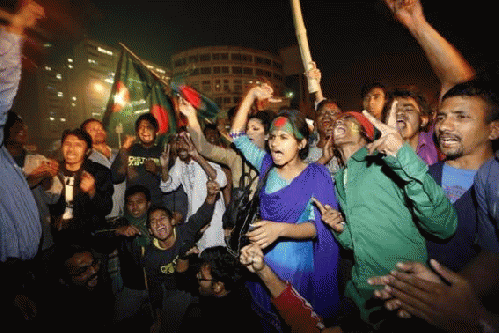 People celebrate after hearing the news of Bangladesh Jamaat-E-Islami leader Abdul Quader Mollah's execution in Dhaka December 12, 2013., From ImagesAttr