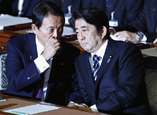 Japanese P.M. Shinzo Abe (R) in parliament as it rejects a no-confidence resolution against his Cabinet., From ImagesAttr