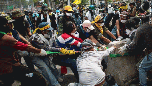 Protesters remove part of a barricade as they attempt to occupy the Government House on Sunday, December 1.