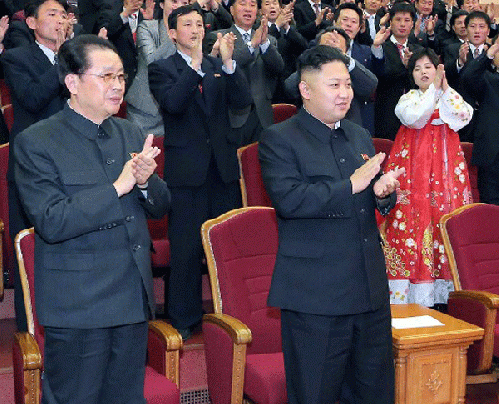 North Korean leader Kim Jong Un (C-front) applauding at a concert in Pyongyang as his uncle, Jang Song Thaek (front L), looks on, April 15, 2013., From ImagesAttr