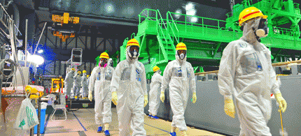 This handout picture taken by the International Atomic Energy Agency (IAEA) on November 27, 2013 shows review mission members of the IAEA inspecting the crippled Tokyo Electric Power CO. (TEPCO) Fukushima Dai-ichi nuclear power plant in the town of Okuma 