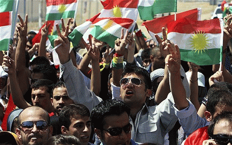 Residents hold Kurdish flags as they protest against Turkish shelling on northern Iraq, outside the Turkish consulate in Arbil, From ImagesAttr