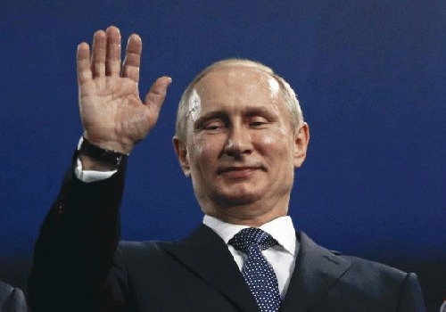 Russia's President Vladimir Putin waves during the closing ceremony for the 2014 Sochi Winter Olympics February 23, 2014, From Images