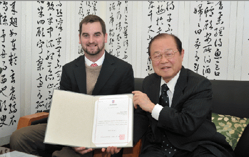 Brady with Chairman Ahn Hwi Joon. The document recognizes the repatriation.