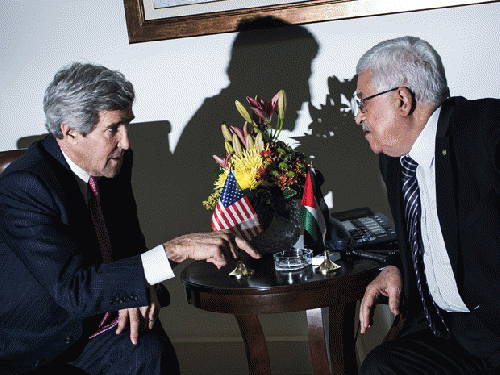 U.S. Secretary of State John Kerry, left, talks with Palestinian President Mahmoud Abbas at the presidential compound in the West Bank city of Ramallah on Saturday, Jan. 4, 2014, From ImagesAttr