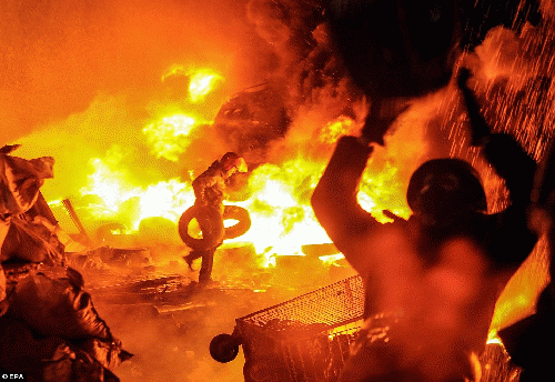 Kiev: Protesters burned tyres sending plumes of black smoke billowing into the air as they faced riot police using tear gas, stun grenades and rubber bullets Kiev: Protesters burned tyres sending plumes of black smoke billowing into the air as they faced riot police using tear gas, stun grenades and rubber bullets