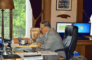 Governor Jay Inslee on the phone with Attorney General Eric Holder, From ImagesAttr