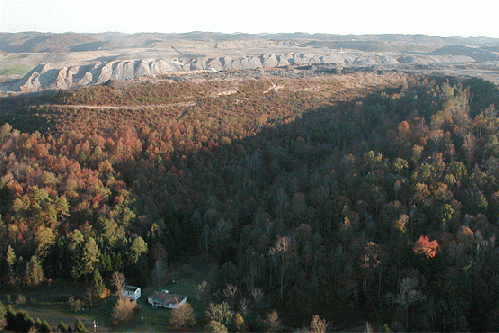 A home is nearly surrounded by the Hobet mountaintop-removing coal mine in Boone County, W.V., From ImagesAttr