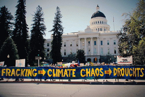 Anti-fracking protesters unfurled a banner outside the California capitol building Saturday calling on Governor Jerry Brown to put a halt to fracking in the state., From ImagesAttr