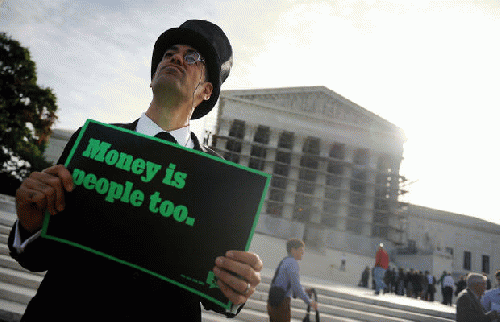 People protest during oral arguments in the case of McCutcheon v. Federal Election Commission at the US Supreme Court in Washington, D.C., The case tests the Constitutional limits of campaign finance laws involving contributions to candidates and politica