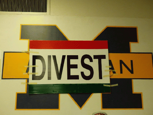 A sign at a student sit-in calling for the University of Michigan to divest from corporations that work with the Israeli military.