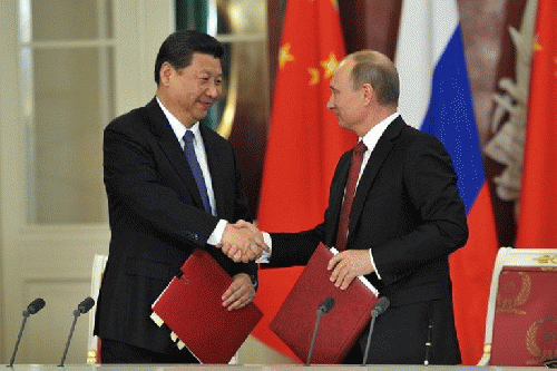 Chinese President Xi Jinping shakes hands with his Russian counterpart Vladimir Putin after approving a joint declaration., From ImagesAttr