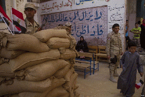 Security outside a polling station in Cairo - 27-May-2014: The New World Order