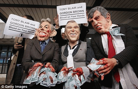 Protesters posing as Tony Blair, George Bush and Gordon Brown outside the inquiry. Their hands were bloodied and they held dollar bills to signify their belief that the Iraq invasion was over oil