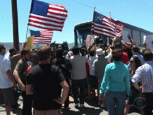 Protesters greeted the first group of 140 undocumented immigrants from Texas as they arrived at the Border Patrol station in Murrieta, Calif., From ImagesAttr