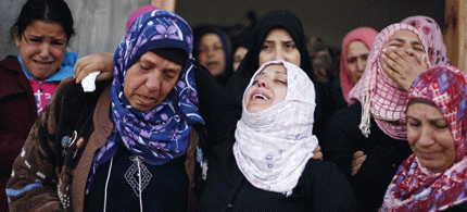 Relatives of Palestinian boy Faris Basyoni, who was killed in an Israeli air strike, mourn during his funeral in Beit Hanoun in the northern Gaza Strip., From ImagesAttr