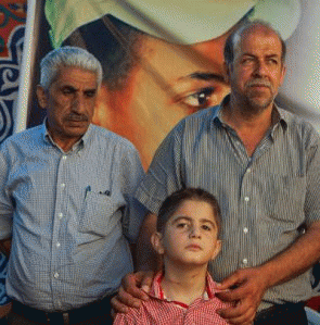 Muhammad Hussein Abu Khdeir's father, center, greeted men who paid their condolences on Saturday.