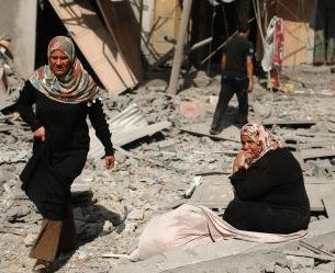A Palestinian woman sitting in front of what was once her home in Beit Hanoun, appears in Ha'aretz.