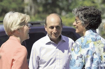 Sen. Elizabeth Warren, left, and state Sen. Dan Wolf chat with Andi Genser, executive director of We Can, during a visit to the We Can facility on Wednesday., From ImagesAttr