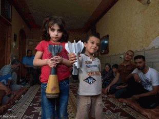 Kamal and Dima Qadan display some of the munitions that fell on Rafah when Israel invoked the Hannibal Directive.