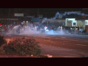 Police deploy tear gas and move in on protesters in Ferguson, Missouri., From ImagesAttr