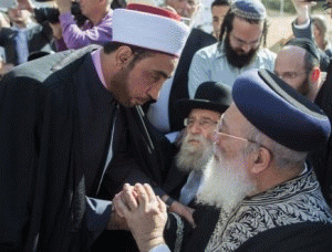 Jerusalem's chief rabbi Shlomo Amar shakes hands with an imam as leaders from the Christian and Muslim communities gathered outside Kehilat Yaakov Synagogue in the Jerusalem neighborhood of Har Nof, From ImagesAttr