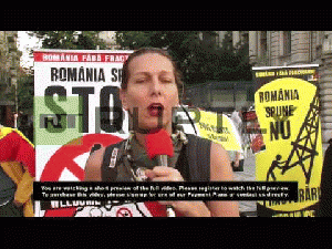 Romania: Anti-fracking protesters target Chevron gas operation 1. C/U Protest sign 2. W/S Crowd of protesters 3. C/U Protest placard 4. SOT Brianna Caragea, protest organiser: .People basically are not only not fed the c..., From ImagesAttr