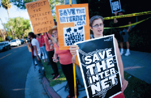 Free Press activists rally for net neutrality on President Obama's motorcade route in Los Angeles.