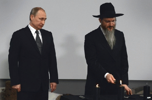 Russian President Vladimir Putin (left) lit a candle at a ceremony in Moscow alongside Russia's Chief Rabbi, Berel Lazar, From ImagesAttr