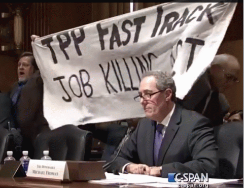 Kevin Zeese protesting at TPP hearing while Michael Froman Testifies, From ImagesAttr