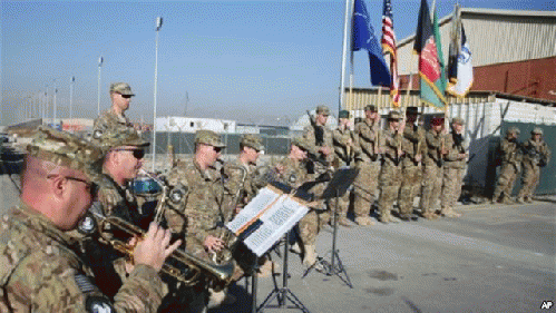 The International Security Assistance Forces band plays during flag-lowering ceremony in Kabul as NATO forces ceremonially end their 13 year combat mission in Afghanistan, Dec. 8, 2014.