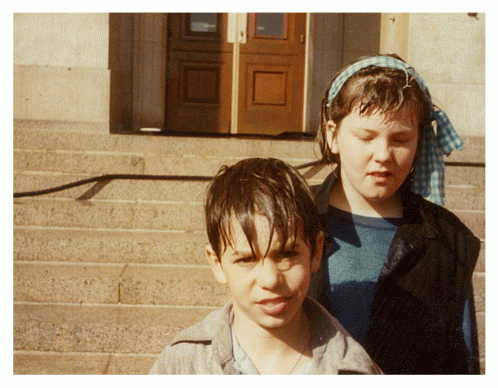 Frida and a friend in front of the River Entrance in April 1985, wet from the hoses used to clean off the blood.