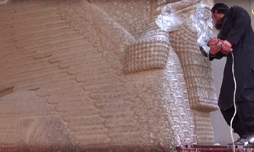 Da'Ish/ISIL militant destroys a winged-bull Assyrian protective deity