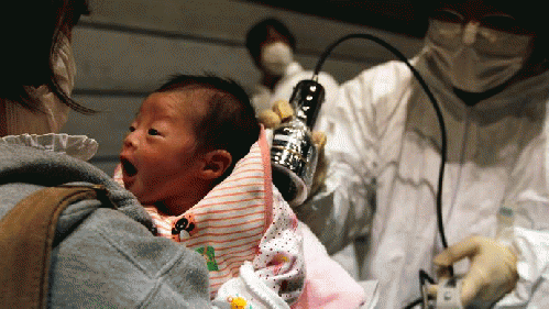 Nagashima Rio who was born on March 15, is tested for possible nuclear radiation at an evacuation centre in Koriyama, Fukushima Prefecture, northern Japan, located about 60 km from the tsunami and earthquake-crippled nuclear reactor, March 31, 2011. (Reut, From ImagesAttr