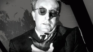 Peter Sellers playing Dr. Strangelove as he struggles to control his right arm from making a Nazi salute.