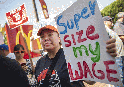 Protesters rally and close down a McDonald's restaurant in Oakland, California, as part of a worldwide campaign for higher pay and the right to form a union., From ImagesAttr