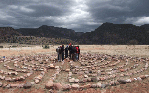 Labyrinth walkers sharing a moment of peace on WLD in the center of  Syzygy labyrinth at Whitewater Mesa Labyrinths