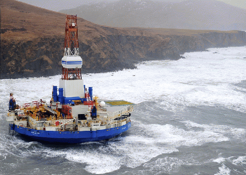 The Royal Dutch Shell conical drilling unit Kulluk sits aground on the southeast shore of Sitkalidak Island, Alaska., From ImagesAttr