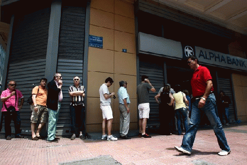 A line of people waited outside an ATM in Athens on Sunday to withdraw their money. Greece's bailout program is set to officially expire on Tuesday., From ImagesAttr